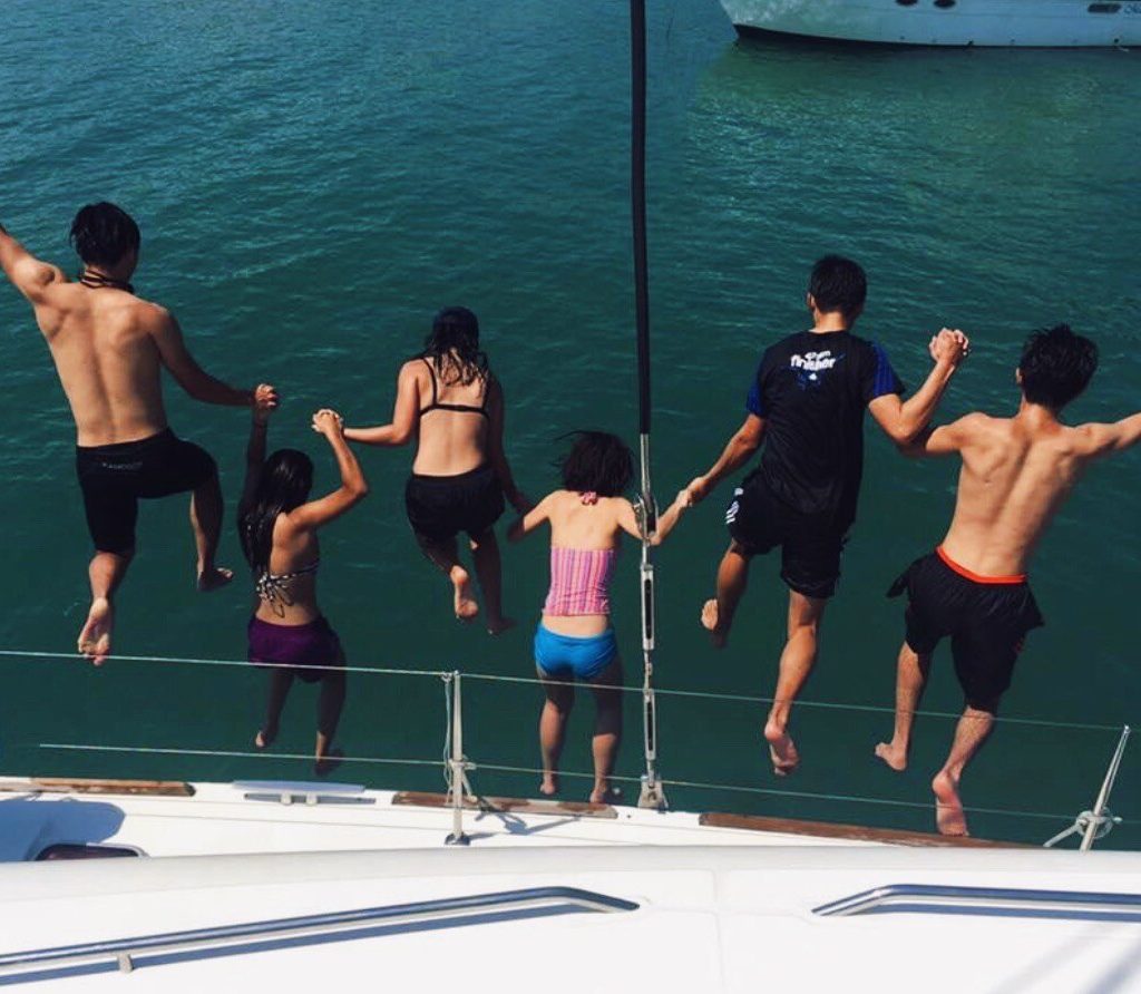 Guests jumping into the sea from SunRise's open platform decks 